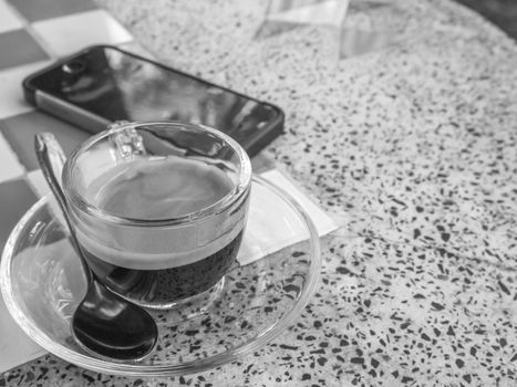 Coffee cup and saucer on table background.