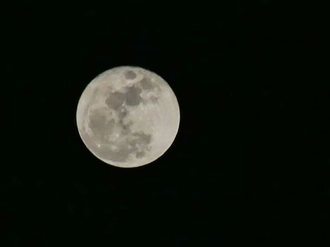 moon over dark black sky at night