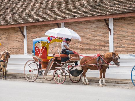 Lampang - December 5 : Don Muang Airport on December 5 , 2015 People in holiday  travel which horse carriage in temple Phrathat Lampang Luang in Lampang, Thailand Thailand.