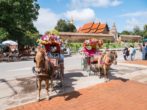 Lampang - December 5 : Don Muang Airport on December 5 , 2015 People in holiday  travel which horse carriage in temple Phrathat Lampang Luang in Lampang, Thailand Thailand.