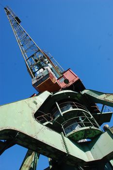 Dockside cargo crane at river port, Kolyma, Russia outback