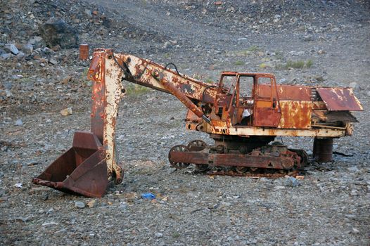 Old broken abandoned rusty excavator at mine, Chersky town region, Yakutia, Russia