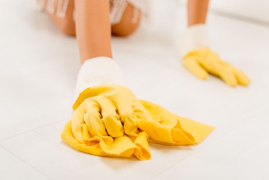 Close-up of a female hands scrubbing floor.