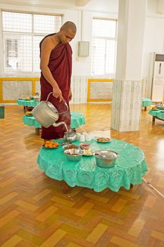 BAGO, MYANMAR - November 26, 2015: Monk serving tea in the monastery from Bago in Myanmar.
Buddhism in Myanmar is predominantly of the Theravada tradition, practised by 89% of the country's population. It is the most religious Buddhist country in terms of the proportion of monks in the population and proportion of income spent on religion.