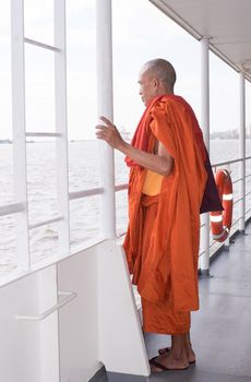 YANGON, MYANMAR - november 24, 2015: Monk on the ferry at Yangon, Myanmar. 
Buddhism in Myanmar is predominantly of the Theravada tradition, practised by 89% of the country's population. It is the most religious Buddhist country in terms of the proportion of monks in the population and proportion of income spent on religion..