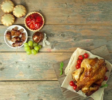 Xmas savory and sweet food selection on top of a wooden background with copyspace