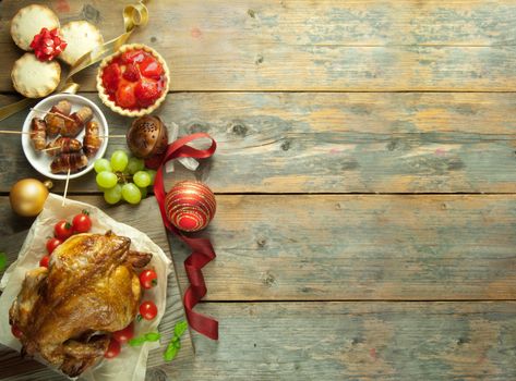 Xmas savory and sweet food selection on top of a wooden background with copyspace