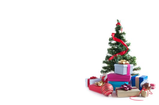 Many wrapped gift boxes around a christmas over a white background