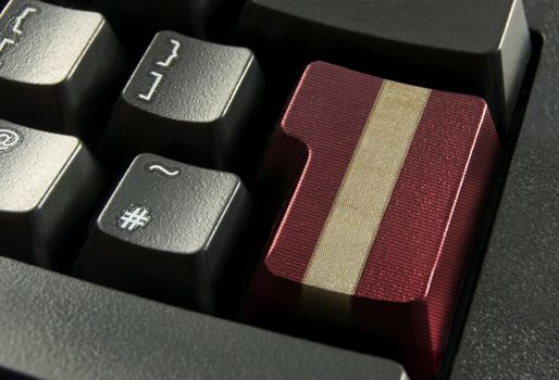 Red computer enter key wrapped with a gold gift ribbon 