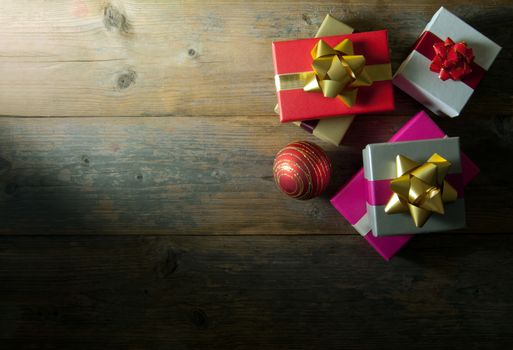 Christmas gifts over a wooden background with copyspace