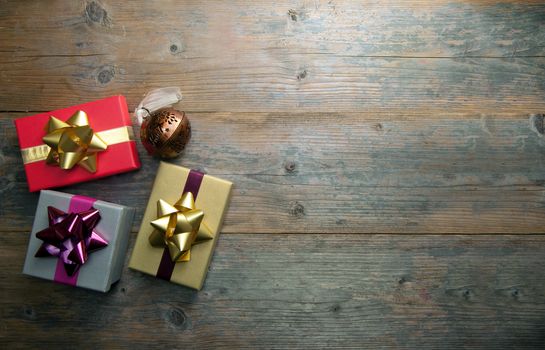 Christmas gifts over a wooden background with copyspace