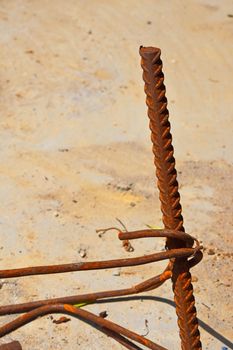 Rusty corroded stained metal pieces of wire, fitting, armature on a dirty concrete floor