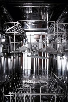 View of the interior of an empty opened dishwasher
