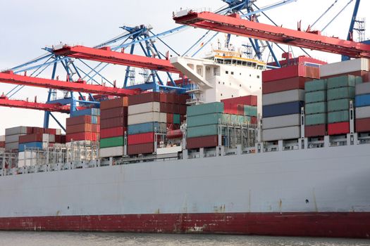 Tug boat with large container ship, Port of Hamburg on the river Elbe, the largest port in Germany