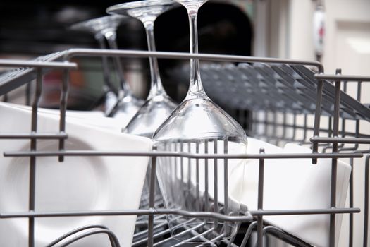 Open dishwasher with clean utensils