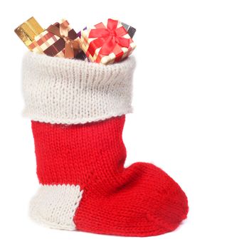 Red Christmas sock with gifts isolated on white background