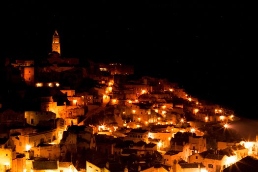 panoramic view of typical stones (Sassi di Matera) and church of Matera UNESCO European Capital of Culture 2019  at night with stars