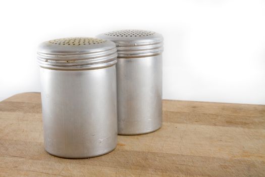 Two metal salt and pepper shakers to be used for food
