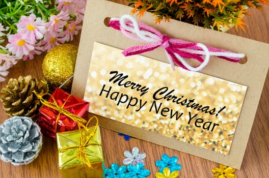 Christmas Greeting card ans happy new year with Christmas decorations with flower on wooden background.