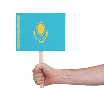 Hand holding small card, isolated on white - Flag of Kazakhstan