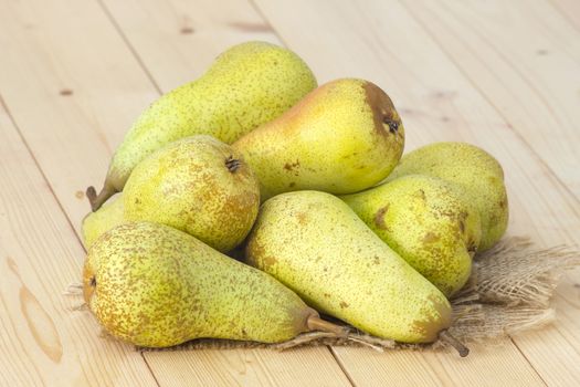 Juicy fresh pears on wooden background
