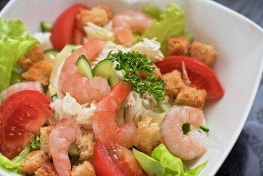 Caesar shrimp salad with cheese and arugula