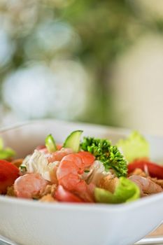 Caesar shrimp salad with cheese and arugula