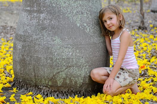 Girl is hugging a very big tree.