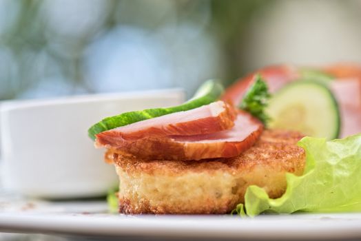pancakes with ham and cucumber with tomato sauce and lettuce