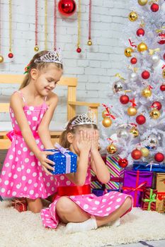 Two funny sisters four girls and six years of playing and having fun in the home New Years interior
