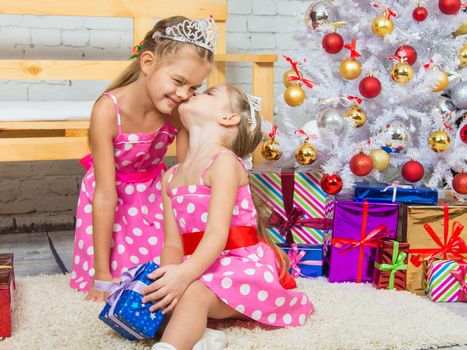 Two funny sisters four girls and six years of playing and having fun in the home New Years interior