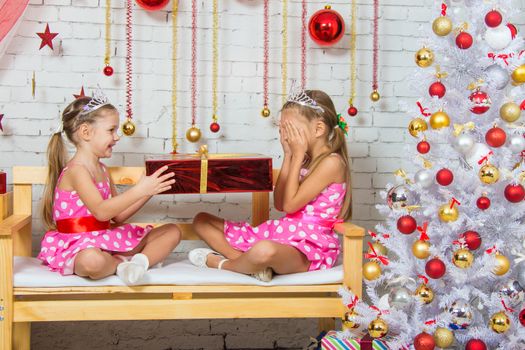Two funny sisters four girls and six years of playing and having fun in the home New Years interior