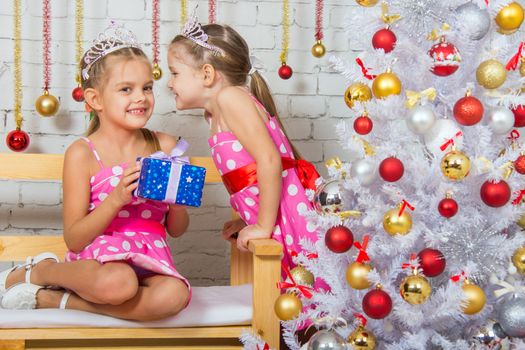 Two funny sisters four girls and six years of playing and having fun in the home New Years interior