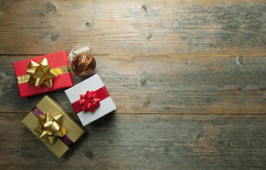 Christmas gifts over a wooden background with space