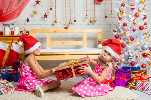 Two funny sisters four girls and six years of playing and having fun in the home New Years interior