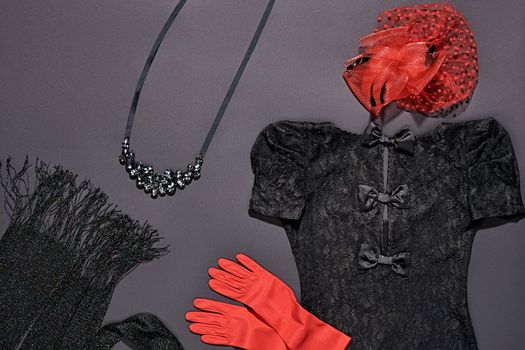 Fashion clothes stylish set, little black lace dress and accessories. Glamor creative, trendy red hat with veil and gloves, necklace and shiny scarf. Unusual elegant evening party style. Vintage retro
