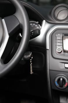 Leather wheel on background with dashboard in new car cabin