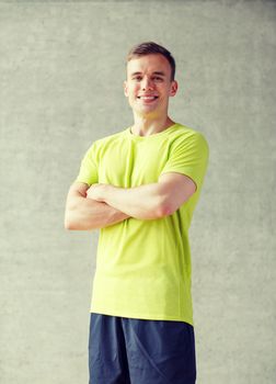sport, fitness, lifestyle and people concept - smiling man in gym