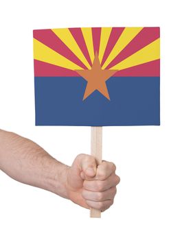 Hand holding small card, isolated on white - Flag of Arizona