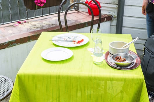 Table in a simple street cafe after dinner.
