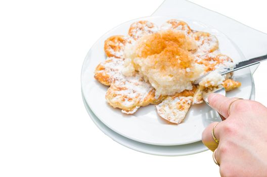 Specialty, Bergisch waffles with rice pudding and cinnamon, isolated against white background.