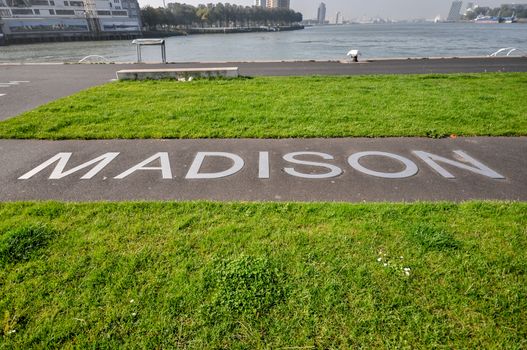 metal lettering MADISON on the pavement on the promenade in front of hotel New York in Rotterdam Holland