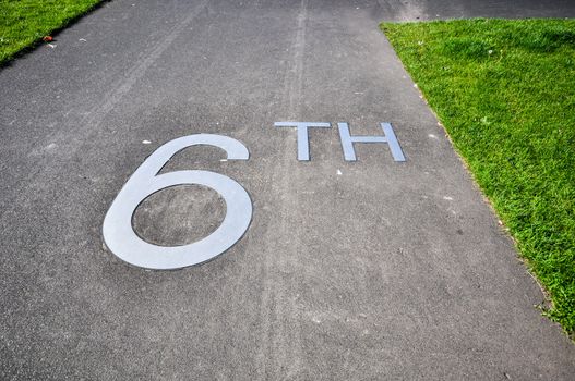 metal lettering 6th on the pavement on the promenade in front of hotel New York in Rotterdam Holland