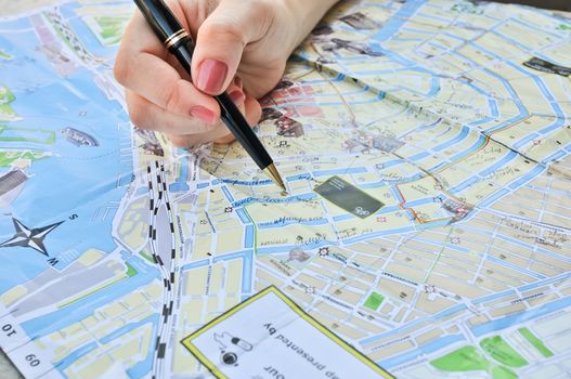 notes with a pen on a map of Amsterdam Holland the Netherlands