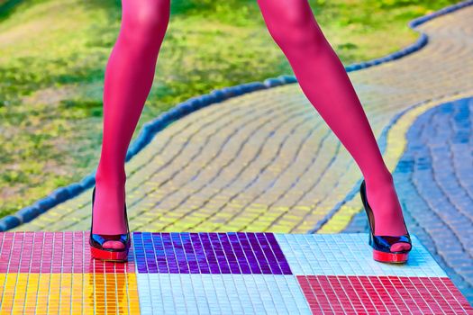 Fashion urban womens sexy legs, pantyhose, stylish heels, people. Vivid shiny multicolored geometry square pattern. Unusual, surrealism abstraction. Girl in trendy shoes, creative mosaic, outdoor