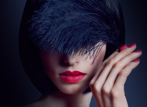 Fashion beauty portrait of nude sexy brunette woman with silky bob hairstyle on dark. Sensual lady mysteriously looks, covering eye by black feather. Girl with makeup, red lips. People face closeup