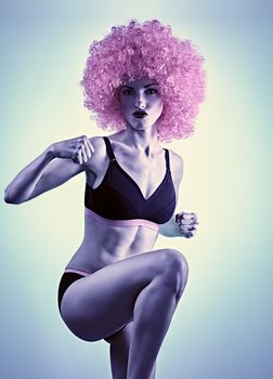 Beauty fashion. Fitness woman, unusual creative. Sexy athletic body, success, winner, people. Angry girl doing knee kick in sport bra, shorts, afro hairstyle on blue, copyspace, toned. Winner concept