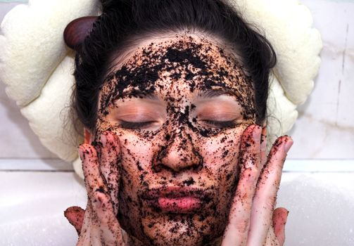 portrait of a girl with eyes closed in a cosmetic mask of coffee