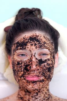 portrait of a girl with eyes closed in a cosmetic mask of coffee
