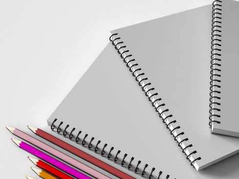 notebook with colored pencils on White background, stationary object